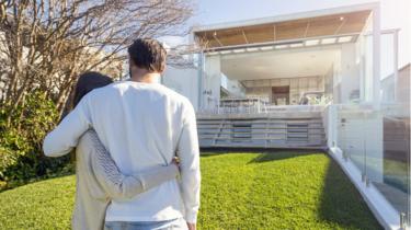 Couple looking at big house