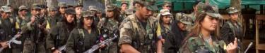 Marxist FARC rebels march through a guerrilla camp deep in the jungles of southern Colombia, 22 June 2001.