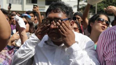 Supporters of the Peruvian ex-president Alan Garcia gather outside the Casimiro Ulloa Emergency Hospital in Lima. 17 April 2019