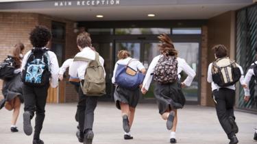 Schoolchildren running into school