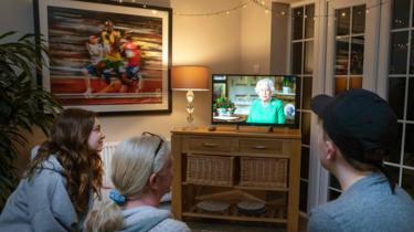 A family watching the Queen's coronavirus speech on TV