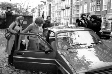 Lady Diana Spencer, surrounded by the media, leaving her Earl's Court flat to get into her car