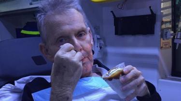 Ron McCartney eating the ice cream in the ambulance