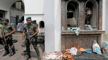 Sri Lankan soldiers stand guard outside the Kochchikade church in Colombo