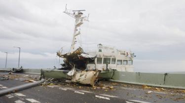 A picture provided by Japan Coast Guard Kansai airport Coast Guard air base shows a tanker that crashed into the bridge linking Kansai International Airport