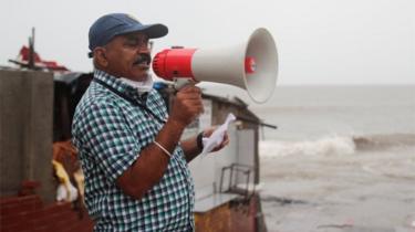 A Brihanmumbai Municipal Corporation (BMC) official makes an announcement to stay indoors over a loudspeaker before cyclone Nisarga makes its landfall, in Mumbai, India June 3, 2020.