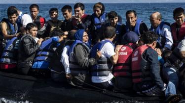 Refugees arrive in an inflatable boat on the Greek island of Lesbos