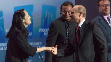 Russia's President Vladimir Putin (R) greets Meng Wanzhou, of the Chinese technology giant Huawei, at the VTB Capital Investment Forum "Russia Calling!" in Moscow in October 2014