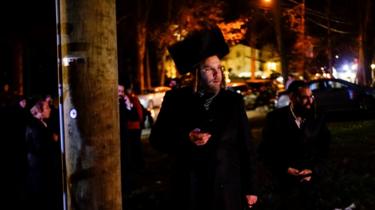 Jewish people try to take a look of the area where 5 people were stabbed at a Hasidic rabbi"s home in Monsey
