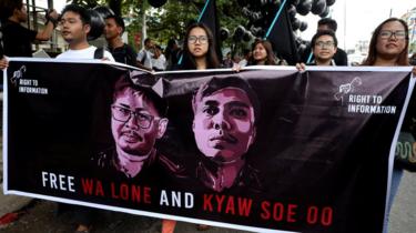 Protesters with banner calling for the journalists to be freed