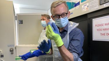 The BBC's Fergus Walsh with a vial of the vaccine