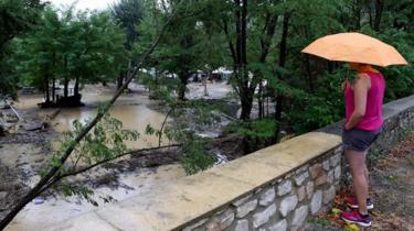 A person is looking at a flooded camping as storms and heavy rains sweep across France on August 9, 2018 in Saint-Julien-de-Peyrolas, southern France.