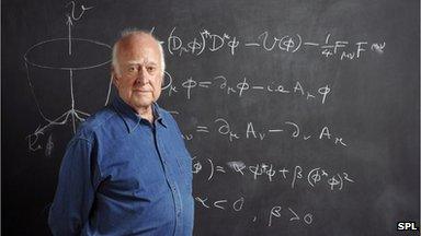 Prof Peter Higgs pictured with the Higgs mechanism equation on a blackboard