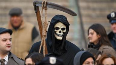 A movie extra dressed as the grim reaper in New York City