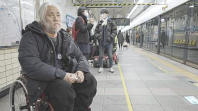 Park Kyoung-seok, who uses a wheelchair, on the platform at a Seoul subway station.