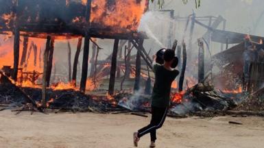 A man tries to put out a fire