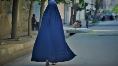 A woman walks down the street in Kabul in May 2022 (file picture)