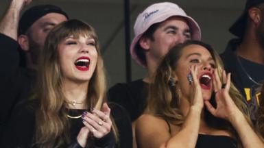Taylor Swift and Blake Lively cheer from the stands during the game