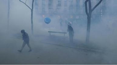 People running away from tear gas on street
