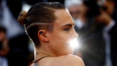 Cara Delevingne poses on the red carpet at the Cannes Film Festival in France, on 24 May 2022