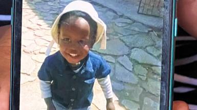 Keketso Saule's aunt shows a photo of her nephew on her mobile phone