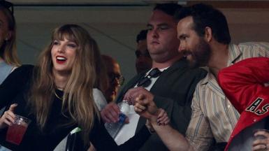 Singer Taylor Swift and Actor Ryan Reynolds talk prior to the game between the Kansas City Chiefs and the New York Jets at MetLife Stadium on October 01, 2023
