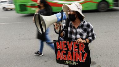 A protester holds a sign during a rally in symbolic remembrance of victims and continued opposition to Martial Law in Quezon City, Metro Manlia, Philippines 21 September 2022