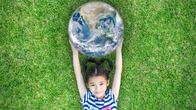 Child holding a globe