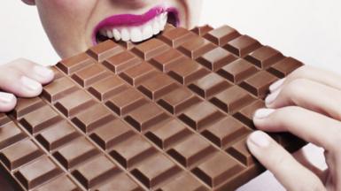 Woman eating chocolate bar