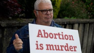 Man holding anti-abortion placard