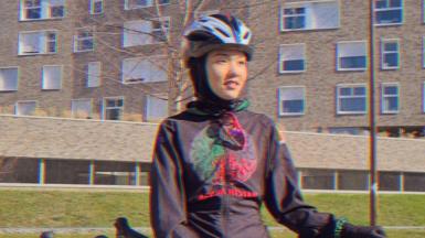 Masomah leaning on her bike