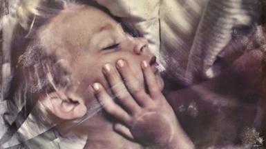 Young child with hand on their face