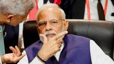 India's Prime Minister Narendra Modi (R) speaks with India's Foreign Minister Subrahmanyam Jaishankar during a session during the G20 Summit in Nusa Dua on the Indonesian resort island of Bali on November 16, 2022