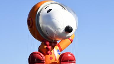 A balloon depicting Snoopy in a spacesuit, at the 93rd Annual Macy's Thanksgiving Day Parade, in 2019, in New Jersey