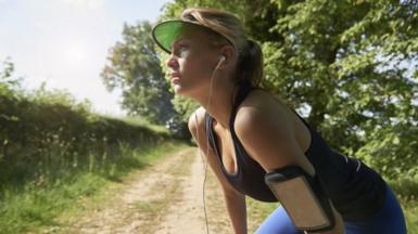 Female jogger listening to music