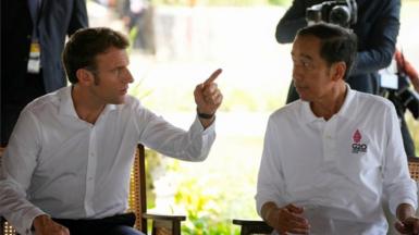 French President Emmanuel Macron and Indonesian President Joko Widodo chat during their visit to a mangrove seeding area as part of the G20 Summit in Denpasar, Bali, Indonesia Nov 16, 2022.