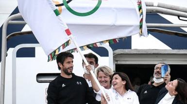 Paris mayor Anne Hidalgo wave the Olympic flag, marking the handover from Japan to Paris, 2021