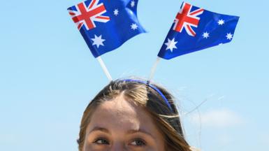 A young woman wearing an Australia flag headband