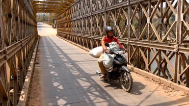 A motor-cyclist drives out of Myanmar along the India-Myanmar friendship road at Moreh, some 120 kms from Imphal, the capital city of Manipur state on March 10, 2017.