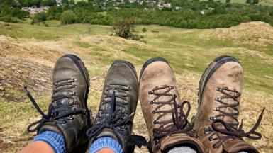 Couple's hiking boots and view of Lake Windermere