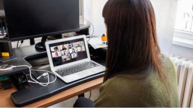 Woman looking at faces on laptop