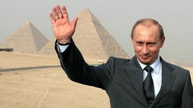 Putin waving his hand next to the pyramids in Egypt