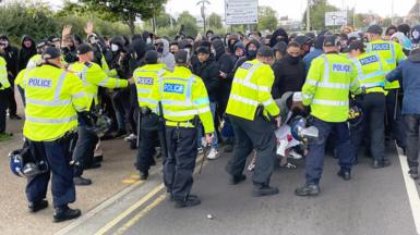 At the end of a largely peaceful protest, a few Muslim men try to break through police lines on Belgrave Road in Leicester, 18 September