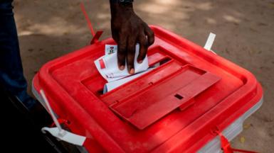 A man places his ballot paper in a ballot box at polling unit in Lagos on March 9, 2019
