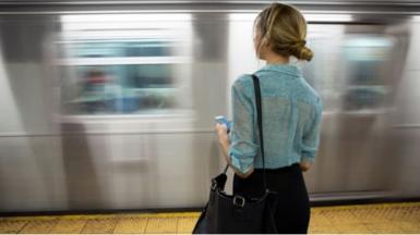 woman standing on train platform