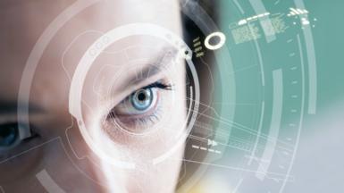 A woman's eyes with a futuristic graphic overlaying the picture