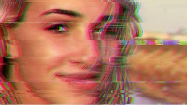 Glitching video still of a woman