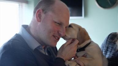 Sean Dilley with a guide dog