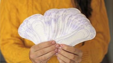 Woman holding sanitary pads in hands
