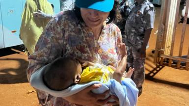 Aid worker with baby